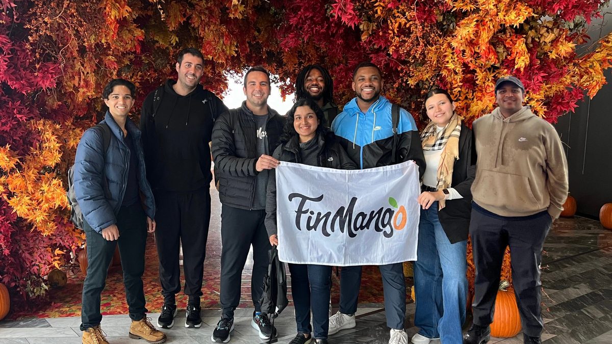 The FinMango team holding the FinMango flag