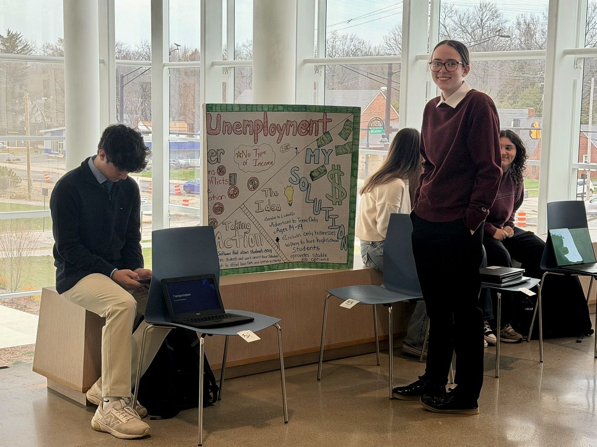 Barrier Breakers students presenting their poster on unemployment in the Kent State University atrium